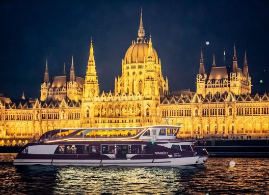 Hungarian Parliament lit at night, Cruise ship in the front phone Hungarian Parliament lit at night, Cruise ship in the front phone